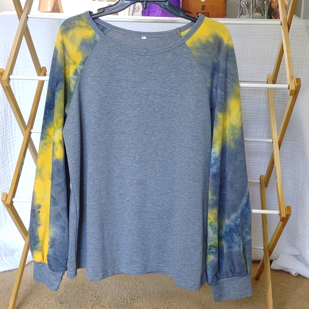Grey long sleeve shirt with yellow and grey tie dye sleeves.